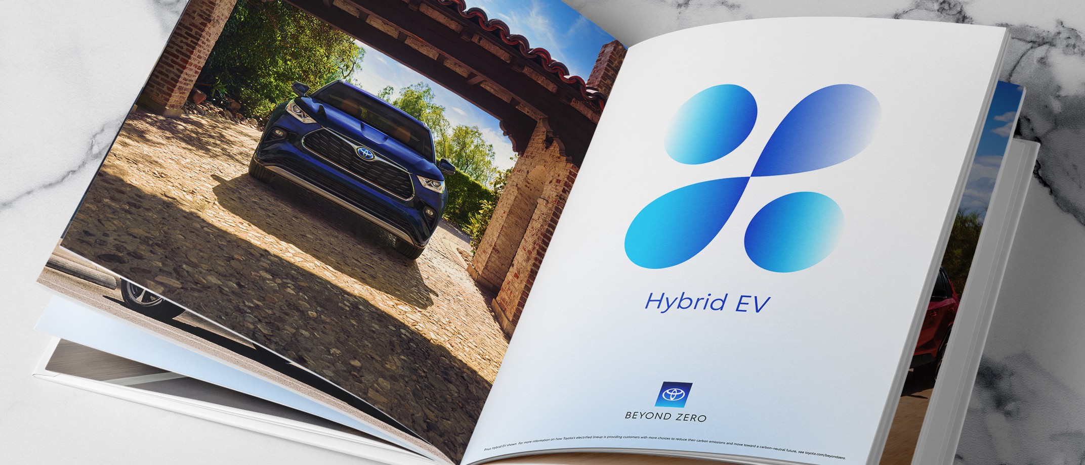 An open Toyota brochure showing a page of a large scale Hybrid EV graphic with the Beyond Zero logo and disclaimer at the bottom.