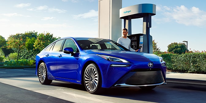 The Mirai in Hydro Blue is parked at a hydrogen pump.