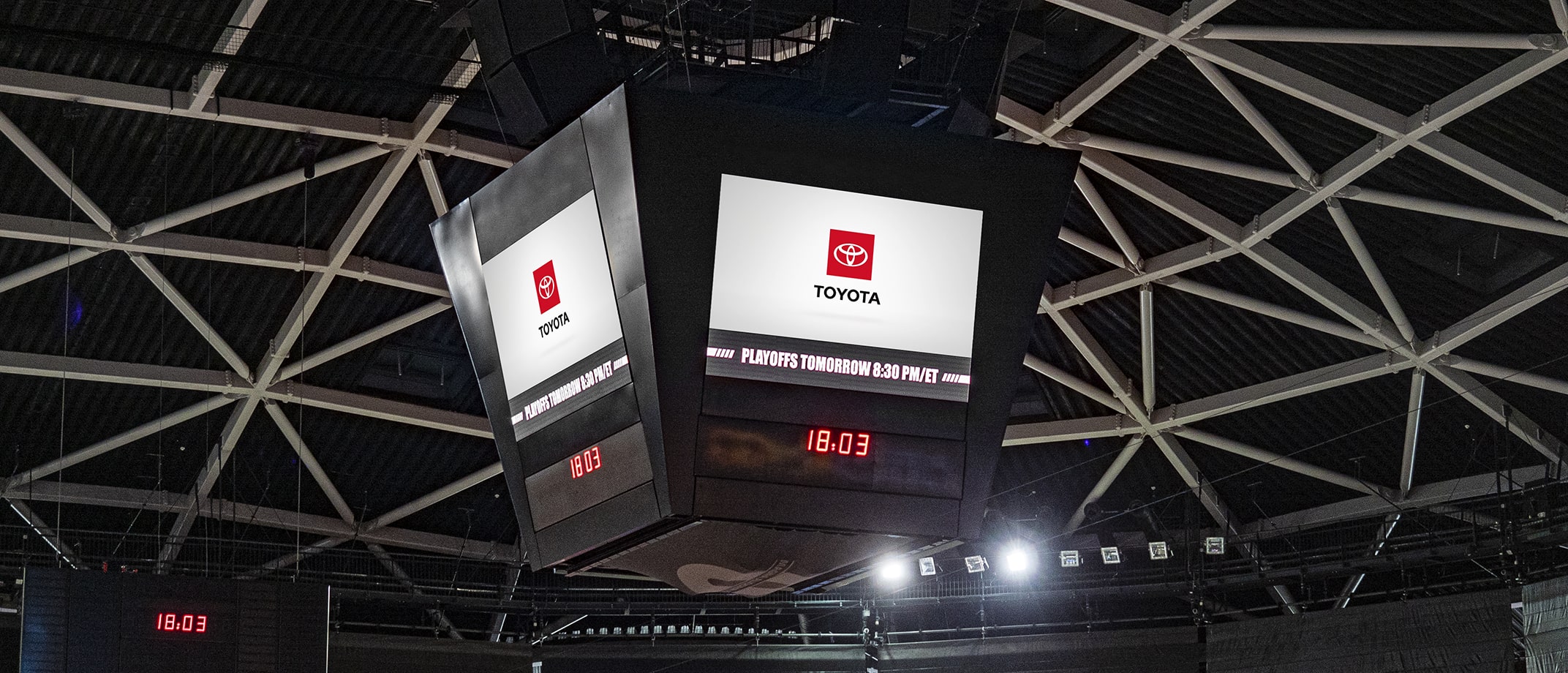 A jumbotron screen in a stadium at night displaying the Toyota logo.
