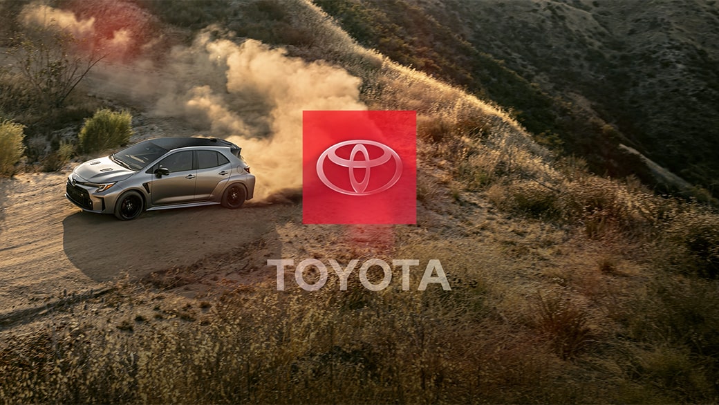 A Toyota logo centered over an image of a vehicle and mountainous terrain representing correct usage.