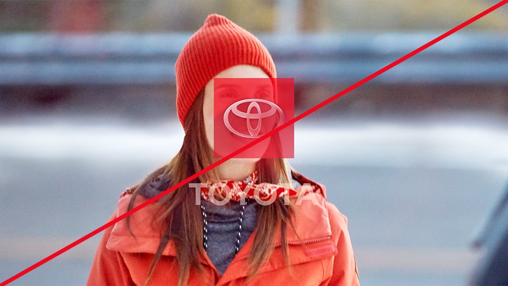 A Toyota logo over a woman’s face dressed in red, representing incorrect usage.