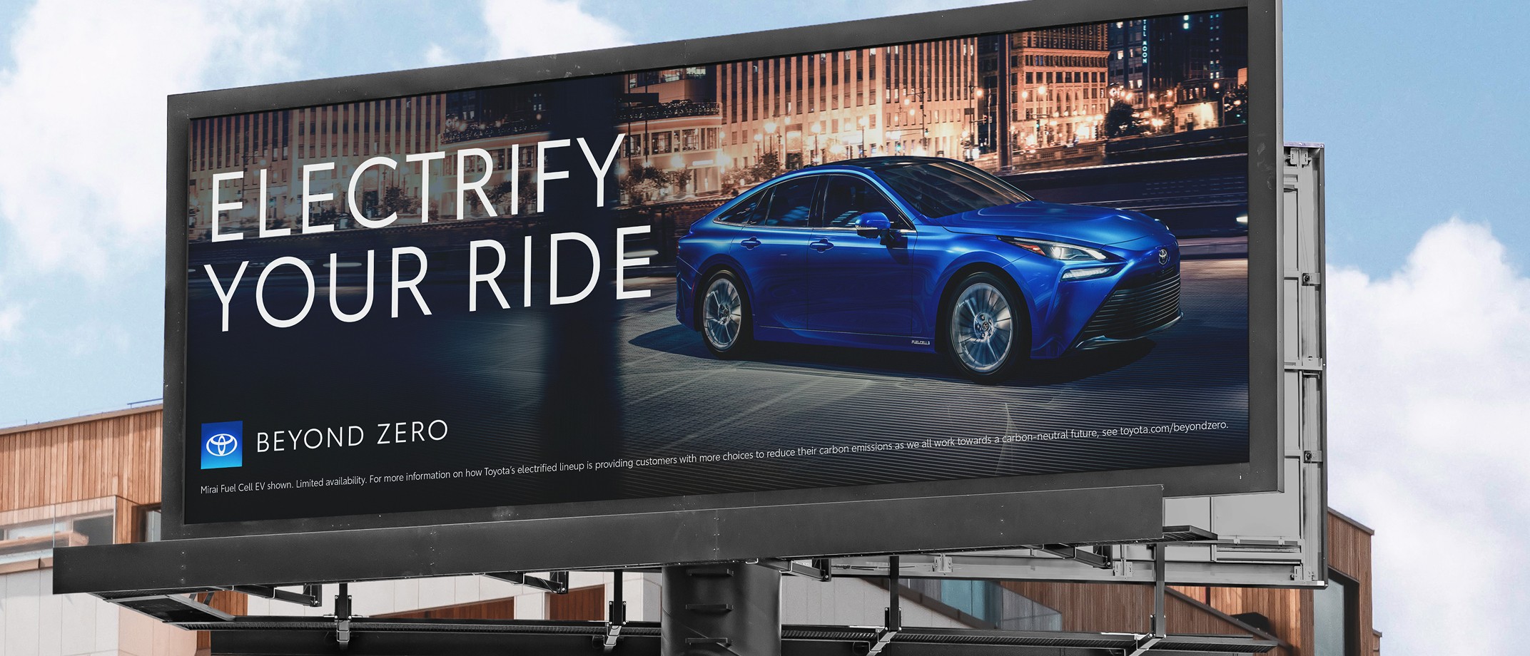 Toyota billboard with a Beyond Zero ad showing a blue Toyota electrified vehicle, the Beyond Zero logo and the headline “Electrify Your Ride.”