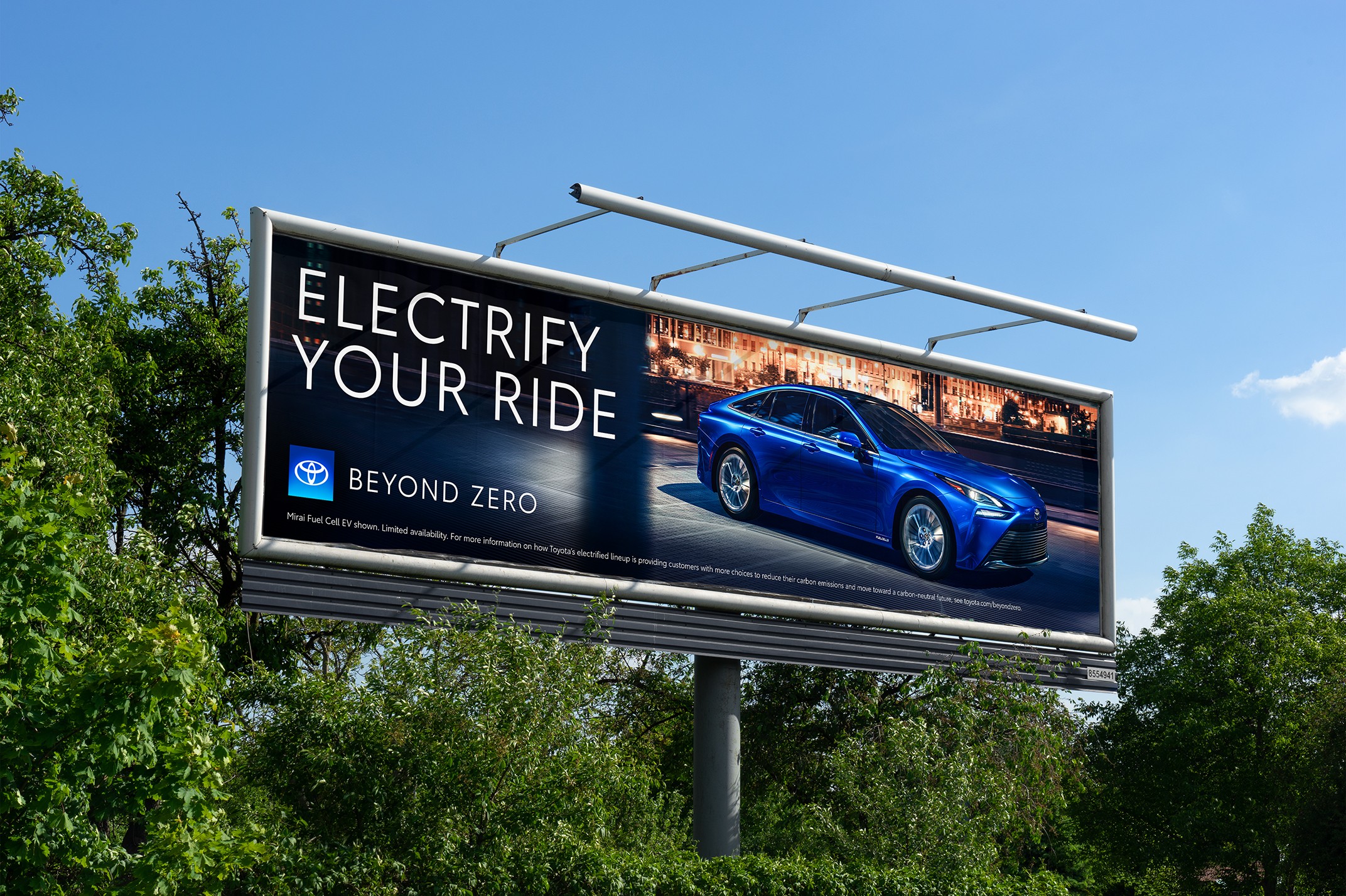 Toyota billboard with a Beyond Zero ad showing a blue Toyota electrified vehicle, the Beyond Zero logo and the headline “Electrify Your Ride.”