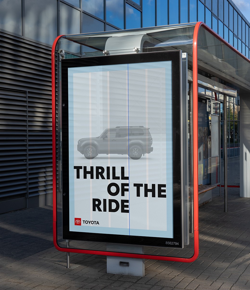 A slider divides an image of an out-of-home board. The slider moves back and forth to show a layout grid of the ad and then the finished ad with imagery.