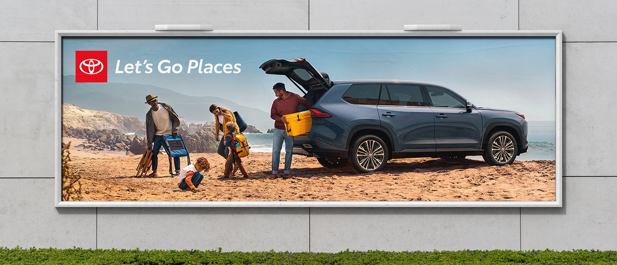 An ad with the Let’s Go Places logo. In the image, next to rocky cliffs and the ocean, a family unloads their Highlander with chairs and a yellow cooler.