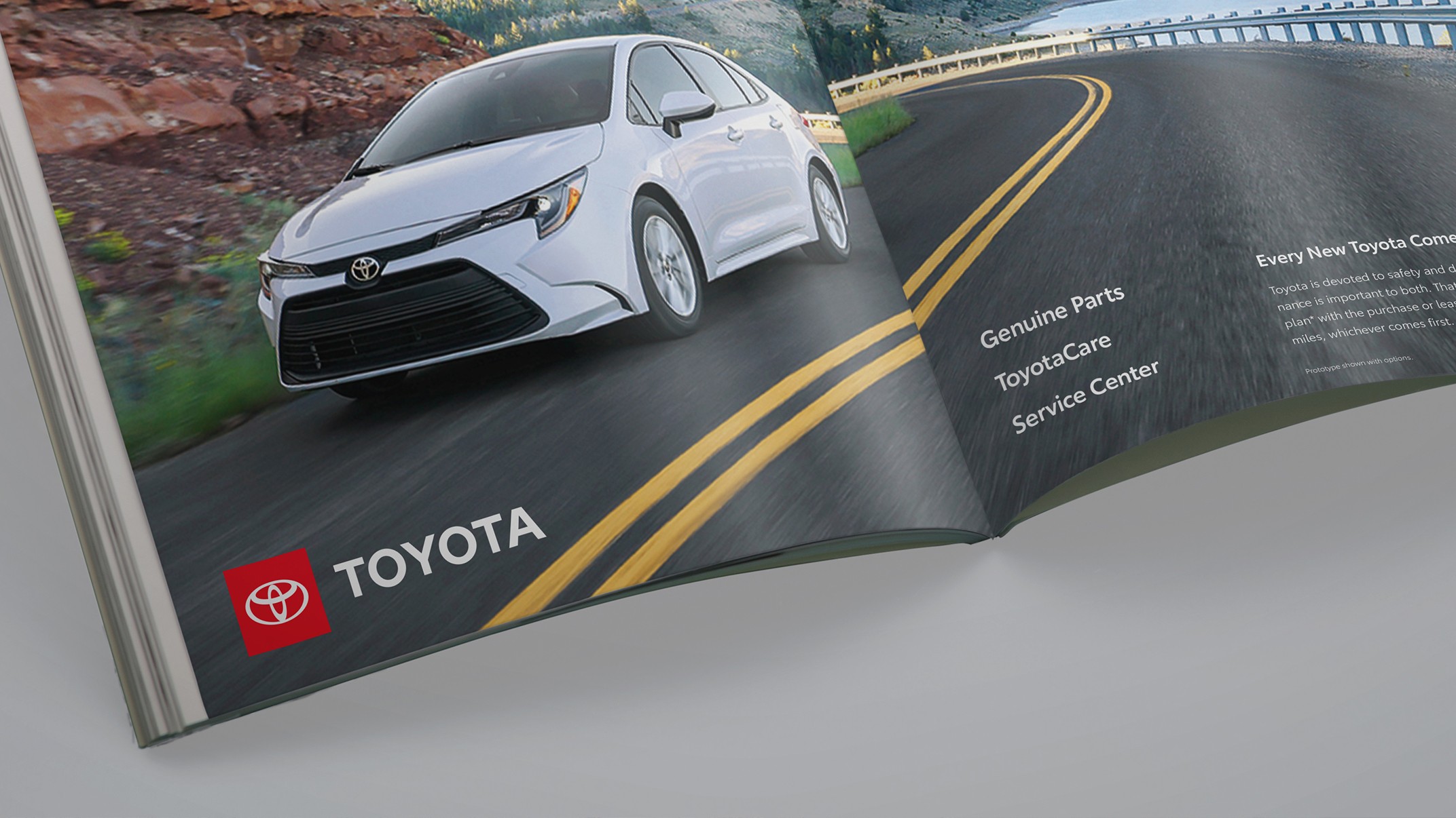 The bottom pages of a magazine show a vehicle driving along a highway. To the left is the Toyota logo. To the right of the page, the text reads “Genuine Parts, ToyotaCare, Service Center.”