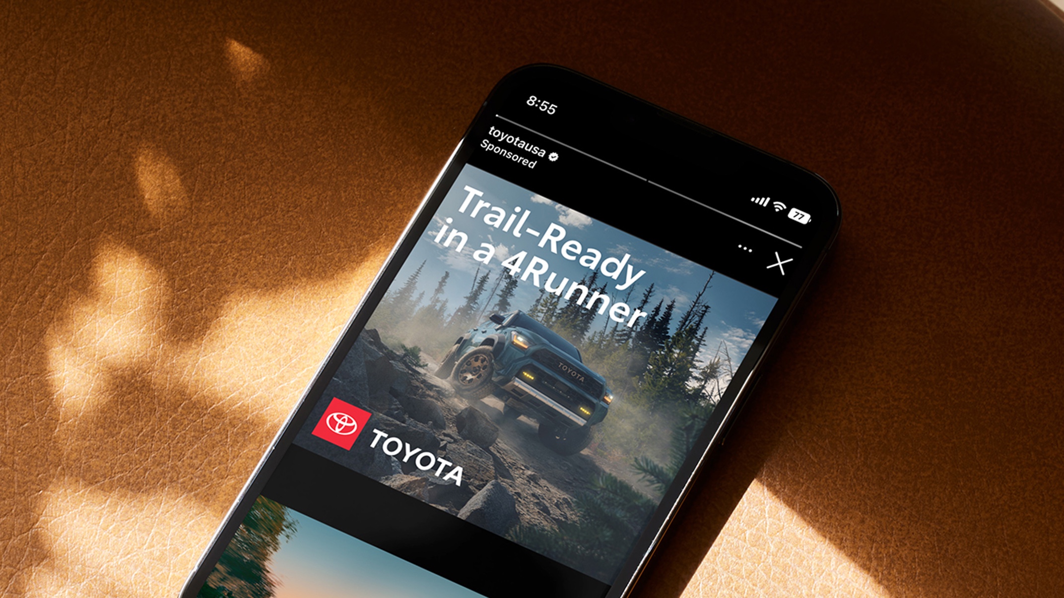 An iPhone screen shows a social media ad with the Toyota logo and a headline reading “Trail-Ready in a 4Runner.”