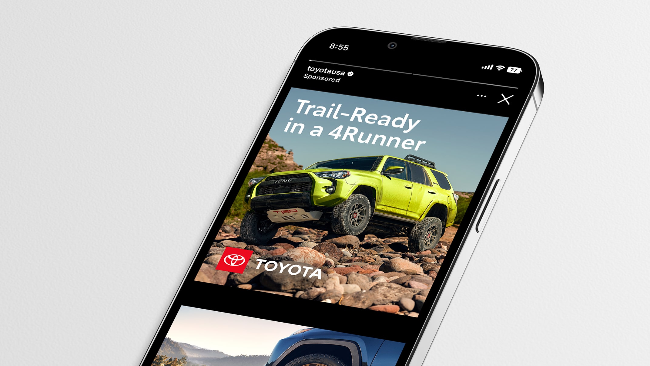 An iPhone screen shows a social media ad with the Toyota logo and a headline reading “Trail-Ready in a 4Runner.”