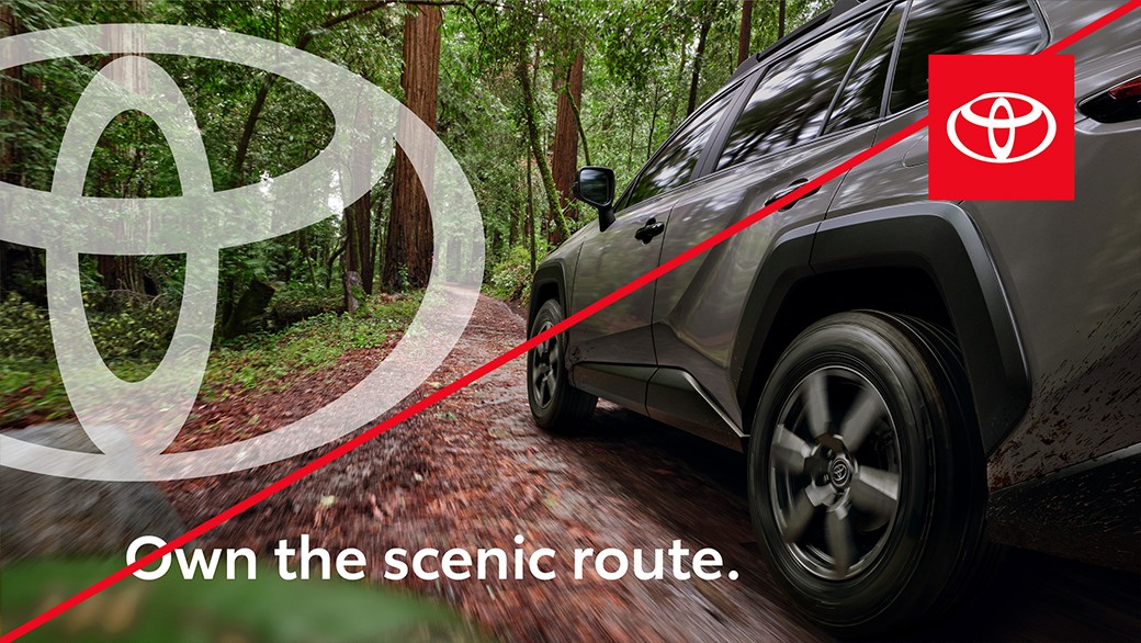 Example ad showing incorrect usage with the Toyota staging platform used by itself in the corner and a large white emblem on the left of the image.