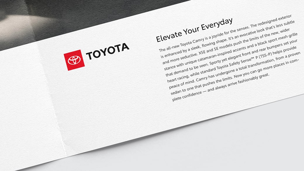 The corner of a magazine is displayed. The text box has the full-color Toyota logo on a white background.