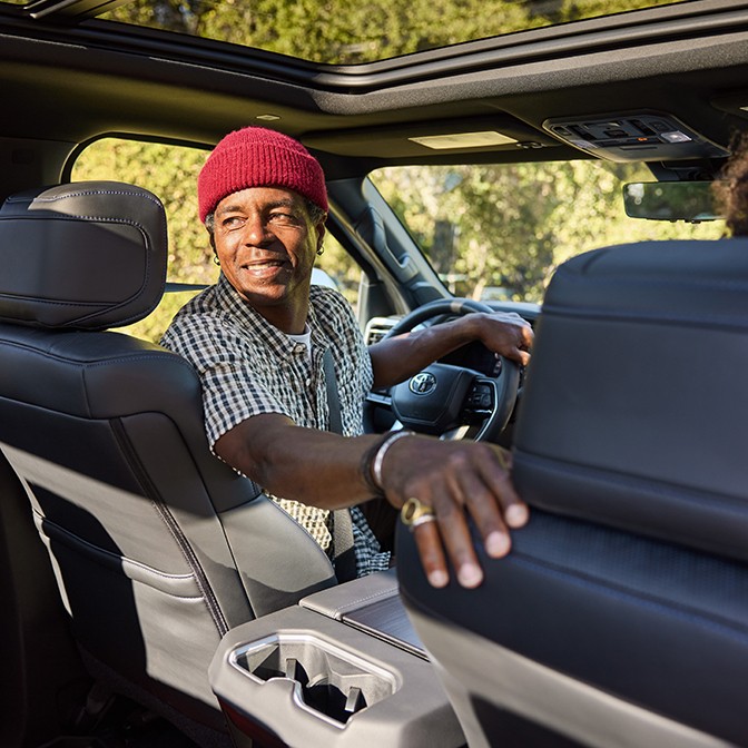 A man in the driver seat looking bacK.