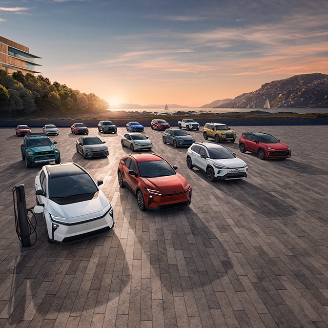 All of Toyota’s vehicles are lined up together in three different rows against a sunset background.