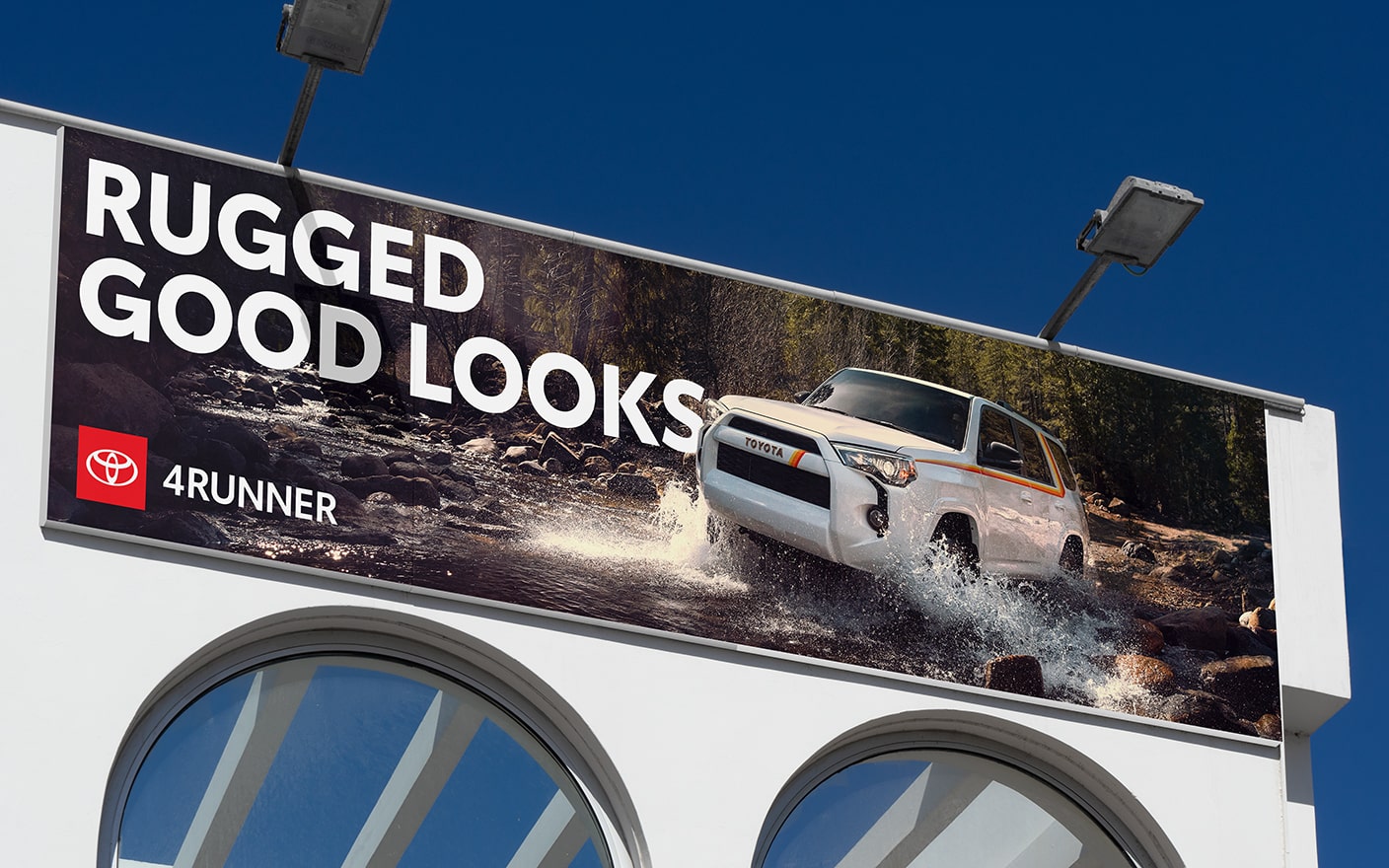 An out-of-home billboard shows a Sequoia off-roading through a creek. The large headline is in all caps reading “RUGGED GOOD LOOKS.”