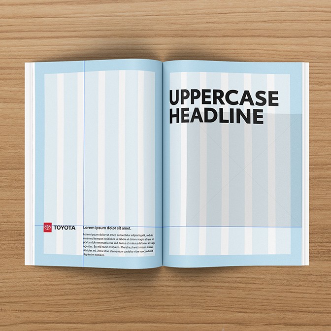 A book is opened to a page with a gridded layout template.