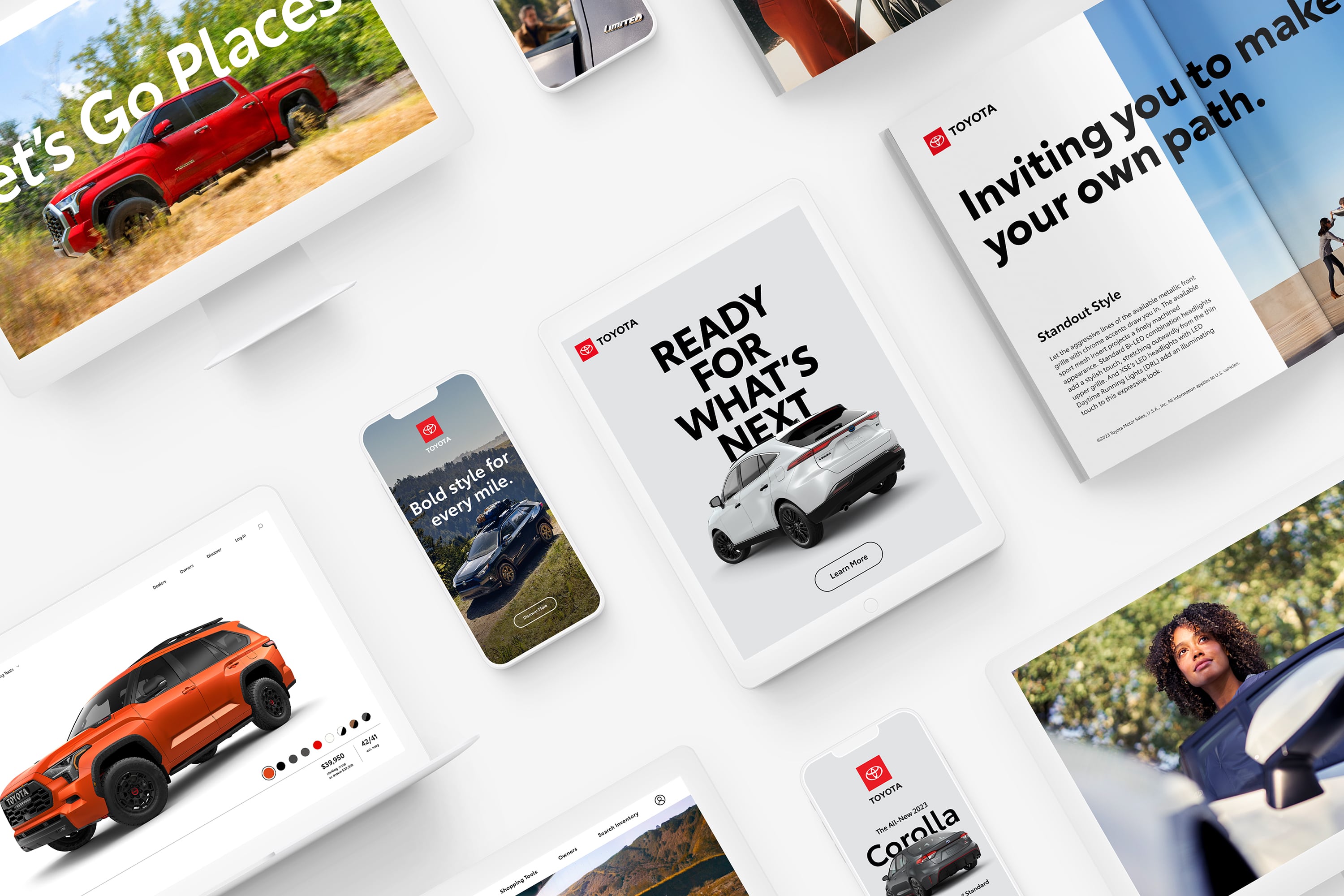 An iPhone, iPad and magazine display images of different Toyota ads and website pages.