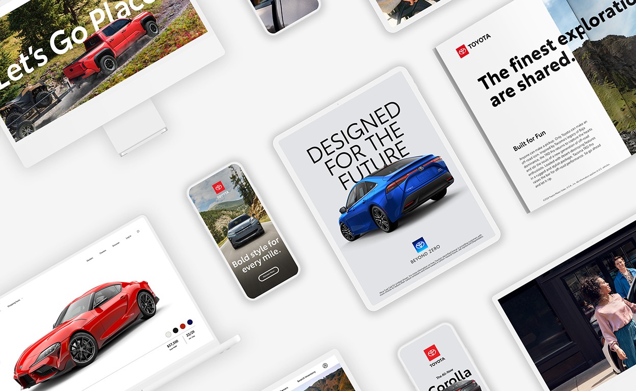 Displayed on a white backdrop, a collage of iPhones, iPads, a computer monitor and a magazine all feature images of different Toyota ads.